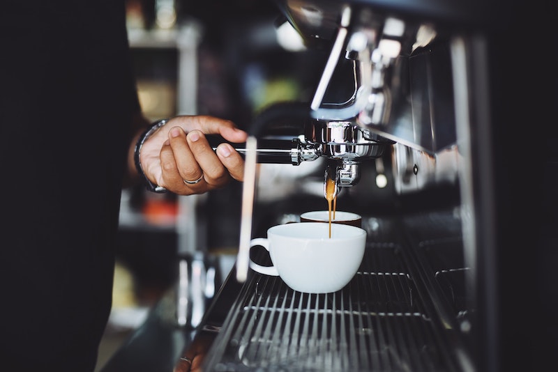 Barista pulling two espresso shots